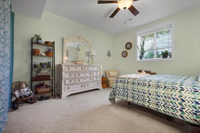 a bed room with a bed window and a chandelier