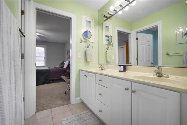 a en suite bathroom with a double sink and mirror