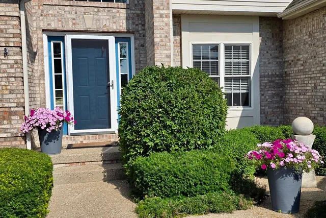 a view of a patio with table and chairs potted plants with wooden floor and fence