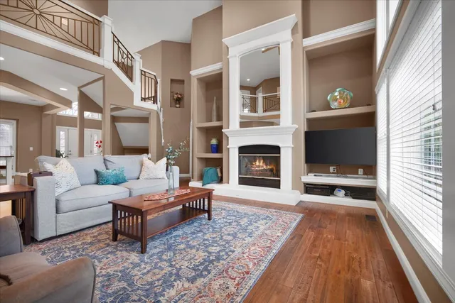 a living room with furniture wooden floor and a fireplace