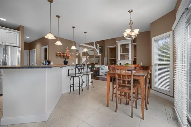 a view of a dining room with furniture and chandelier