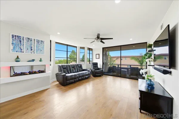a view of a living room and kitchen with furniture