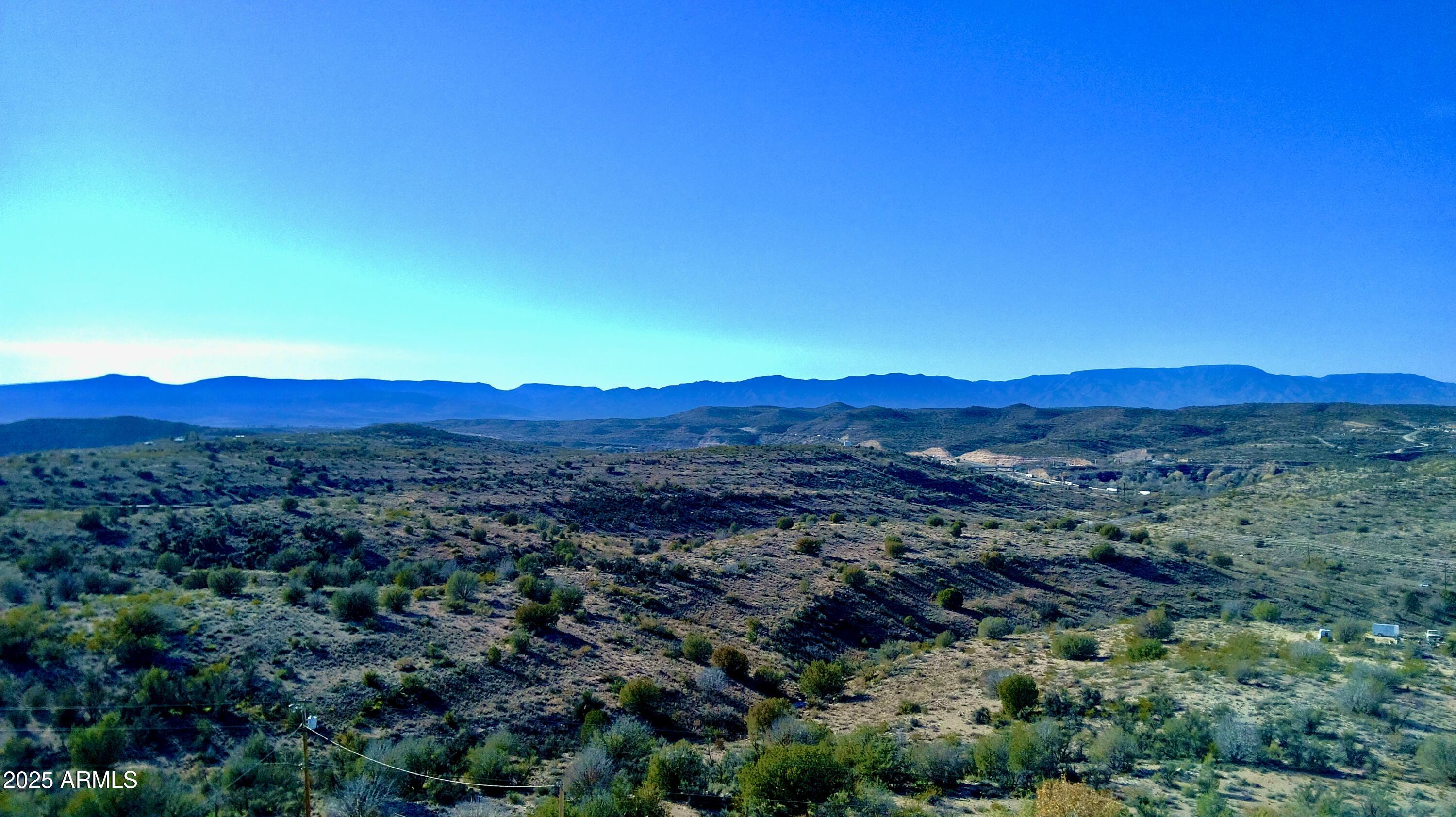 4665 Lazy Lariat Lane Rimrock, AZ 86335 - Photo 24 of 29 a view of a lush green hillside and a fire pit