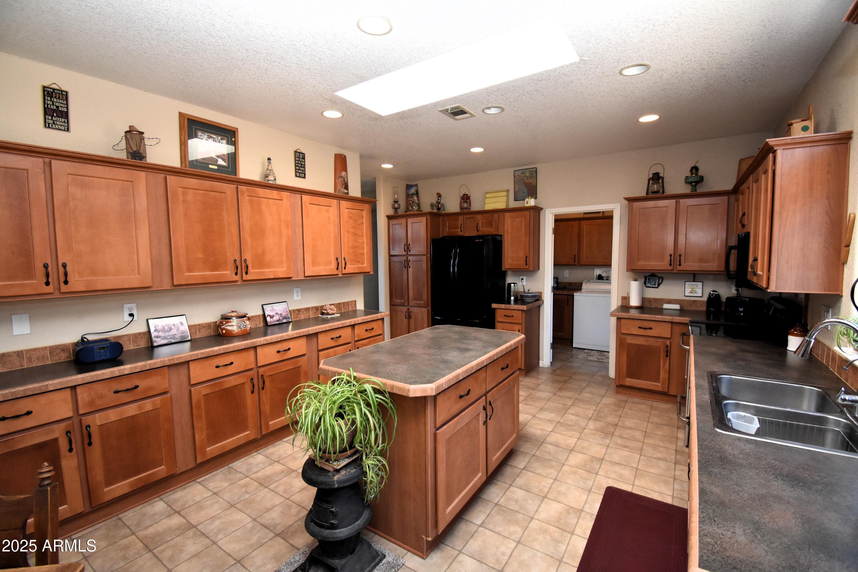 4665 Lazy Lariat Lane Rimrock, AZ 86335 - Photo 5 of 29 a kitchen with stainless steel appliances granite countertop a refrigerator a stove and a sink with wooden cabinets