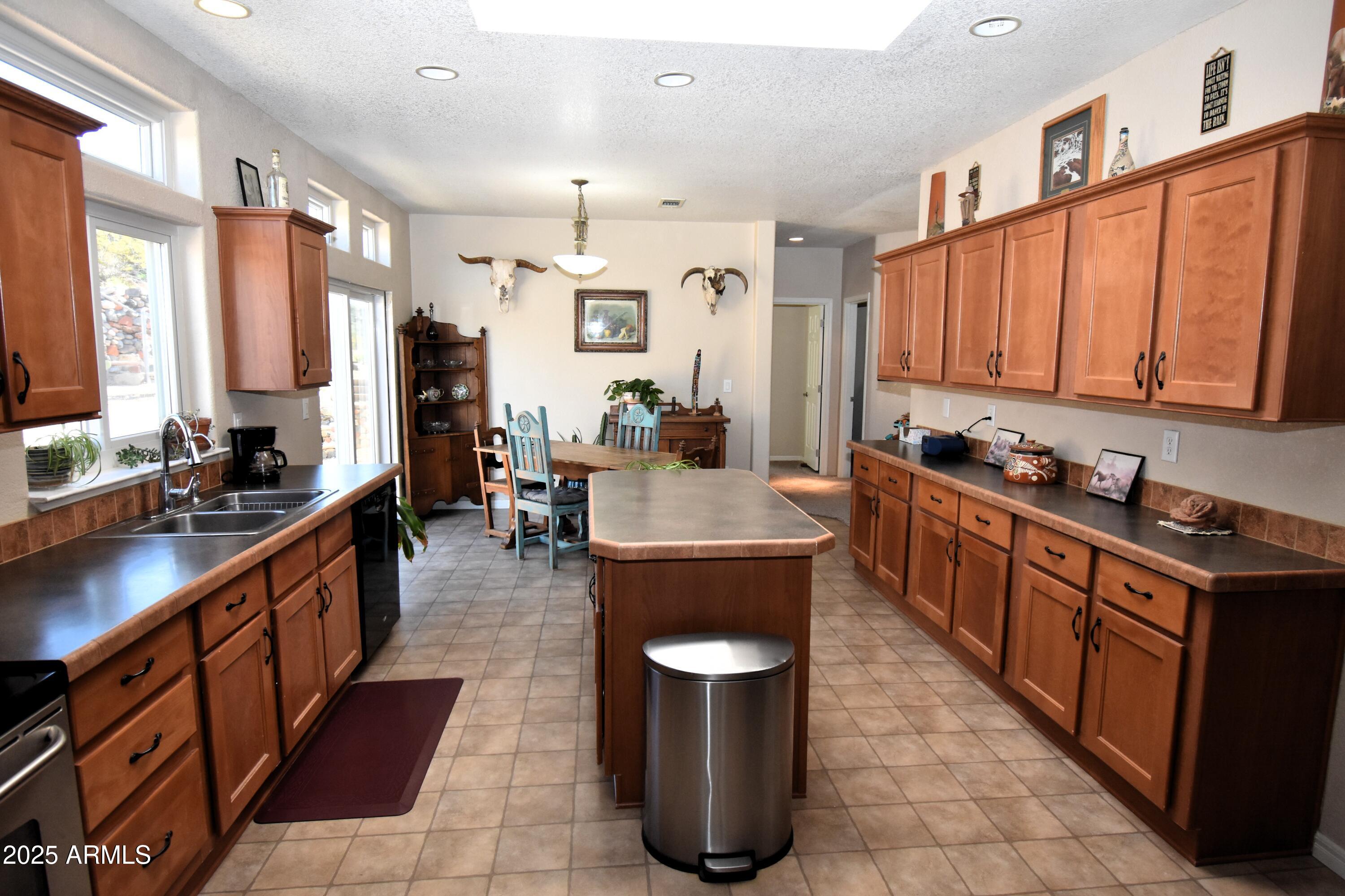4665 Lazy Lariat Lane Rimrock, AZ 86335 - Photo 6 of 29 a large kitchen with stainless steel appliances granite countertop a stove a sink dishwasher and a refrigerator