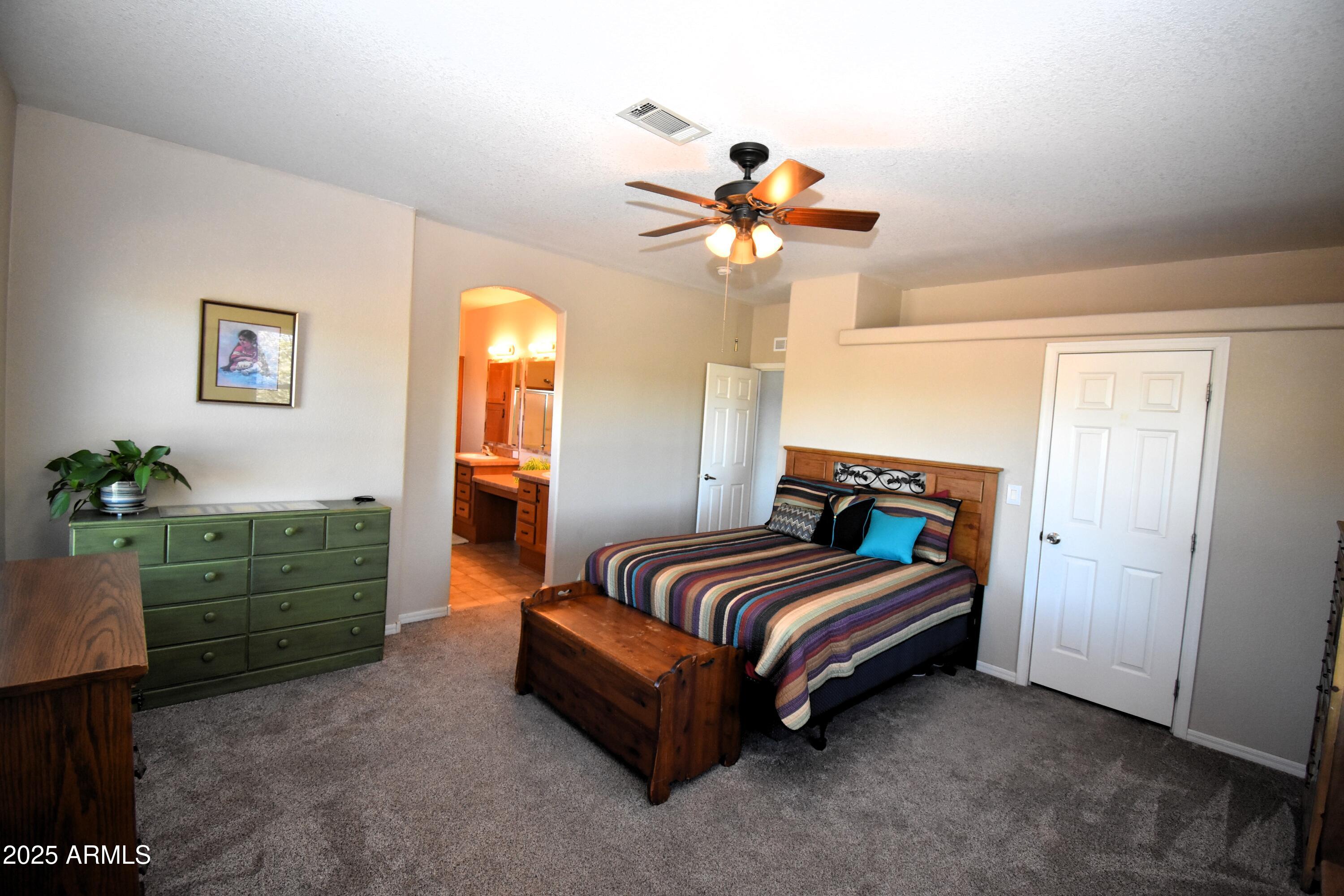 4665 Lazy Lariat Lane Rimrock, AZ 86335 - Photo 8 of 29 a bedroom with a bed dresser and a window