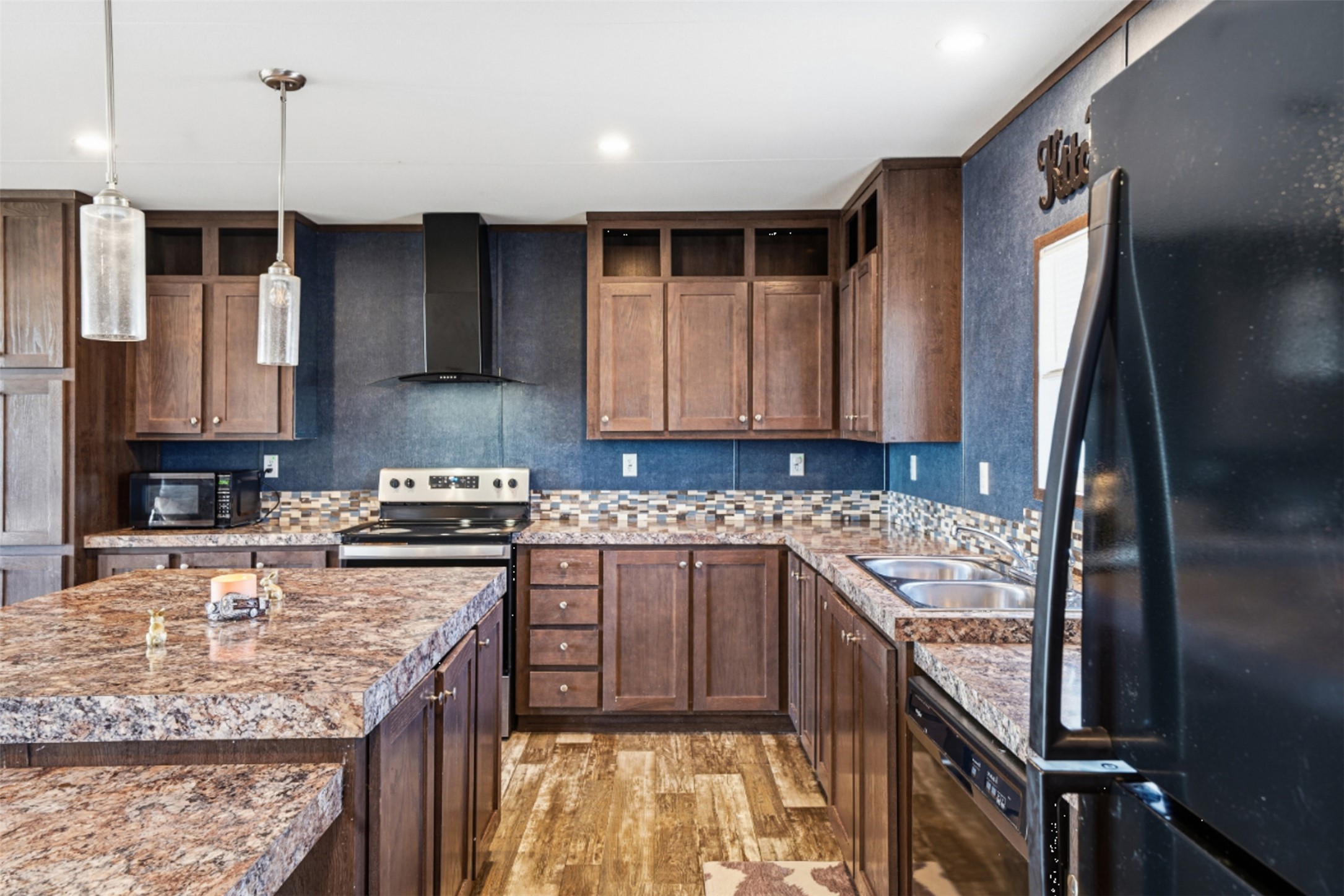 2493 County Road 464 Elgin, TX 78621 - Photo 12 of 40 a kitchen with stainless steel appliances granite countertop a stove a sink a refrigerator and a oven