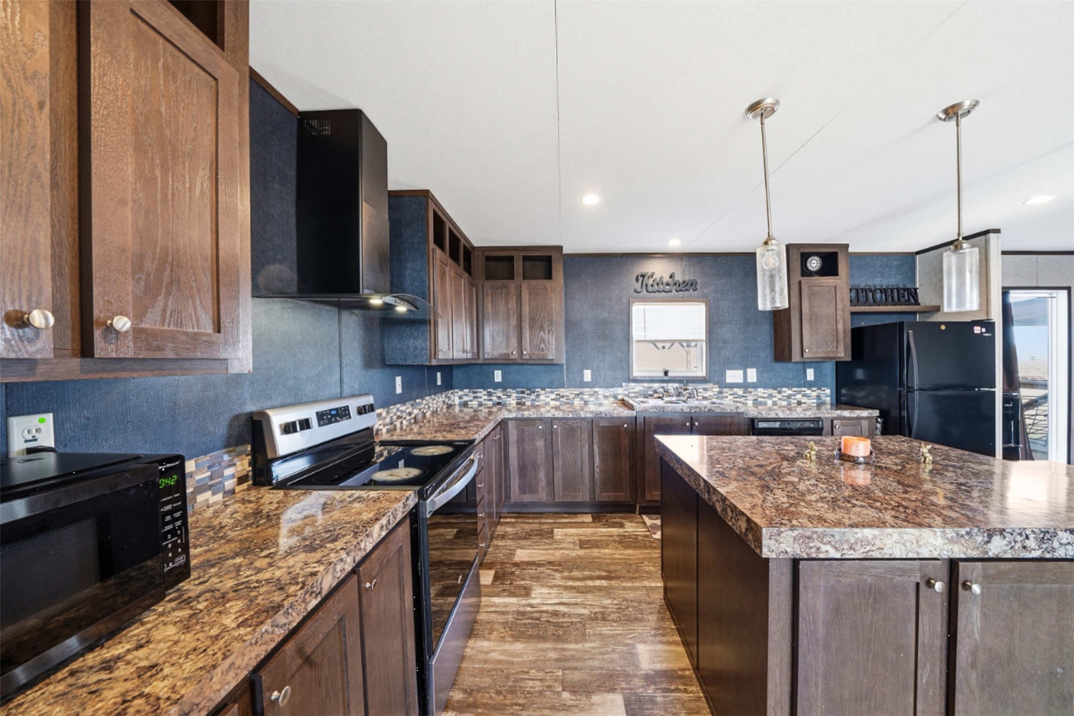 2493 County Road 464 Elgin, TX 78621 - Photo 13 of 40 a kitchen with granite countertop stainless steel appliances and wooden cabinets