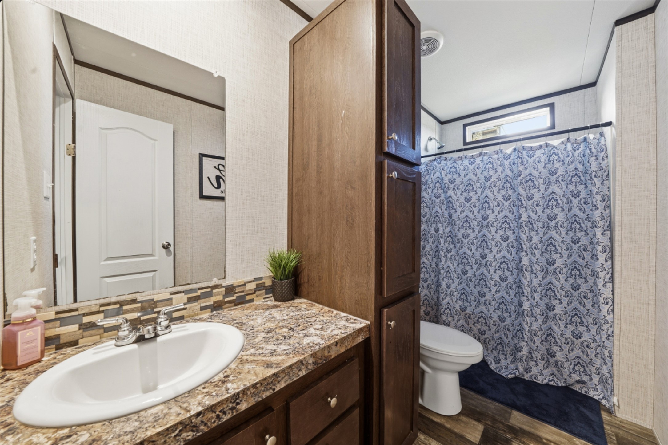 2493 County Road 464 Elgin, TX 78621 - Photo 23 of 40 a bathroom with a granite countertop sink toilet and shower