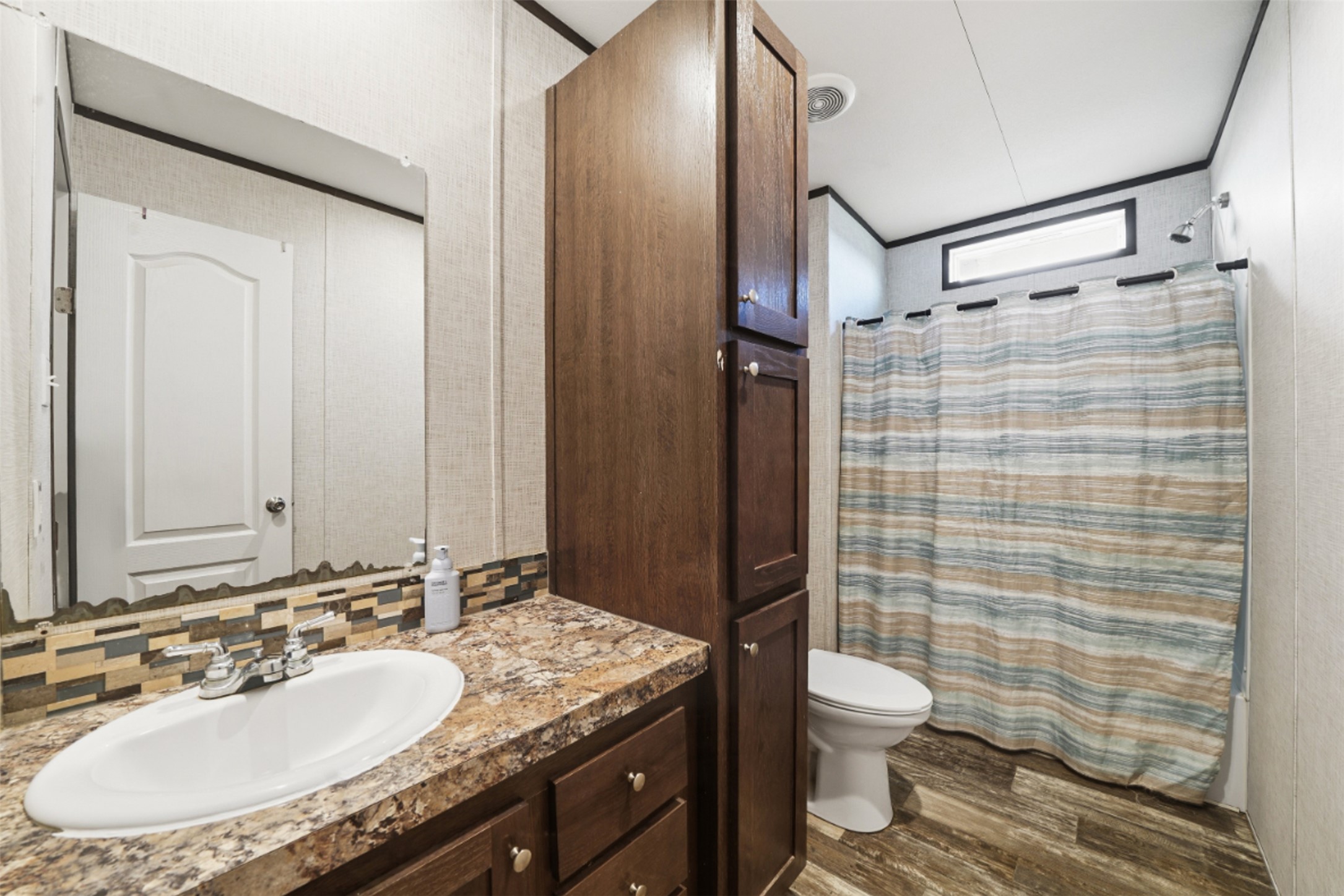 2493 County Road 464 Elgin, TX 78621 - Photo 24 of 40 a bathroom with a granite countertop sink toilet and shower