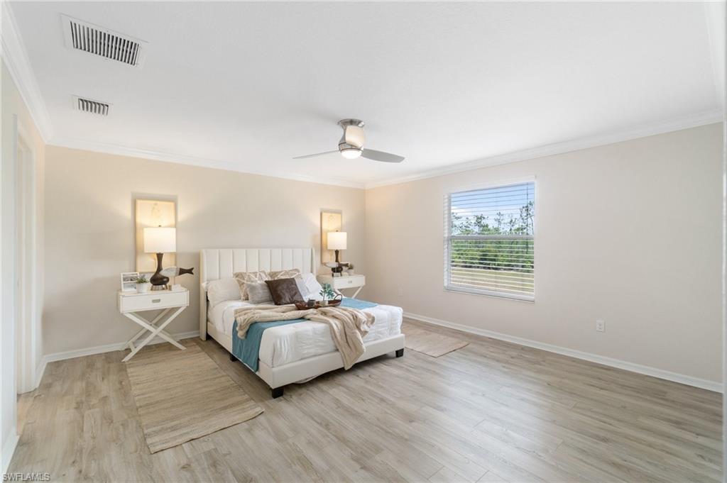 21017 Bella Terra Boulevard Estero, FL 33928 - Photo 23 of 45 a spacious bedroom with a bed and window