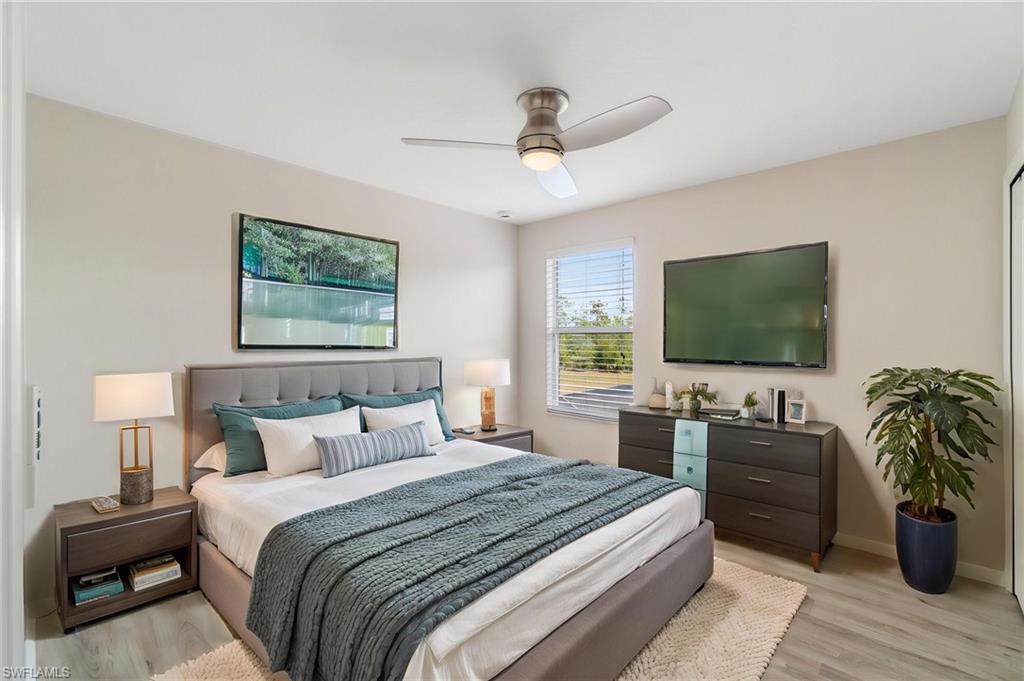 21017 Bella Terra Boulevard Estero, FL 33928 - Photo 27 of 45 a bedroom with a bed and a flat screen television