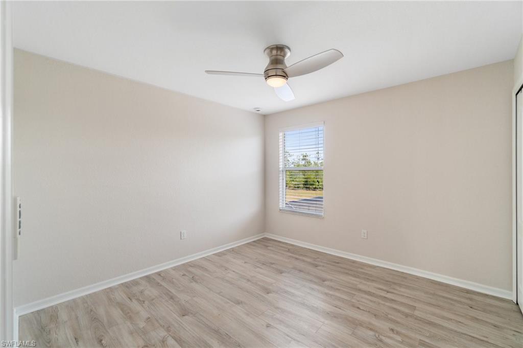 21017 Bella Terra Boulevard Estero, FL 33928 - Photo 29 of 45 an empty room with a window and wooden floor