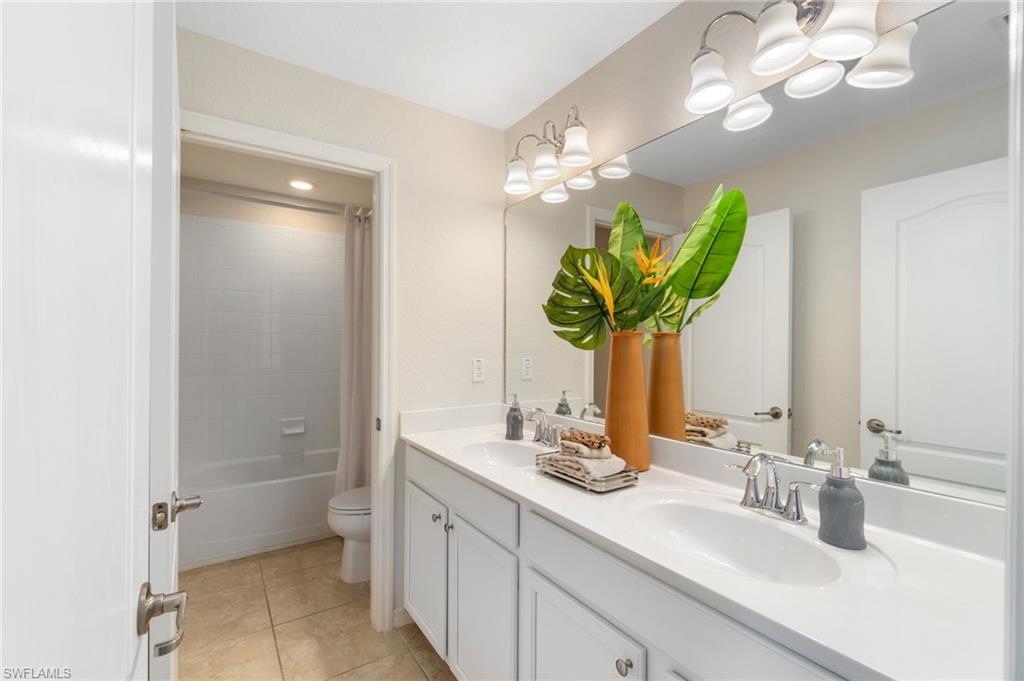 21017 Bella Terra Boulevard Estero, FL 33928 - Photo 30 of 45 a bathroom with a sink a light fixture and a mirror