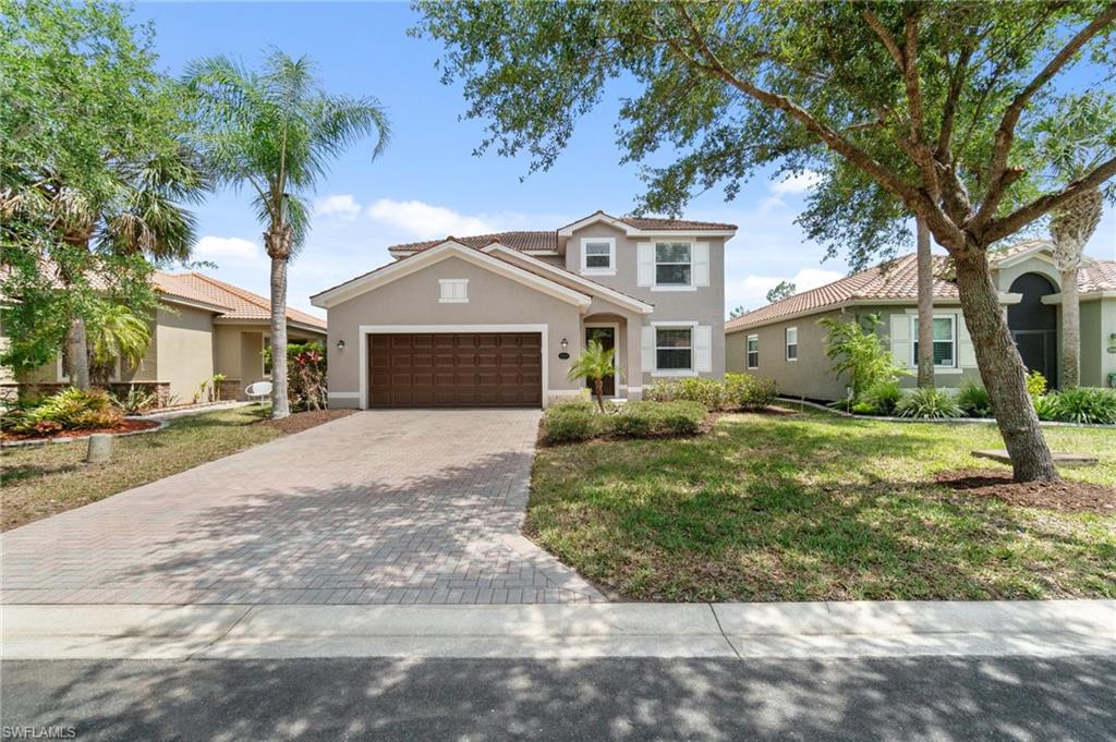 21017 Bella Terra Boulevard Estero, FL 33928 - Photo 3 of 45 a front view of a house with a yard