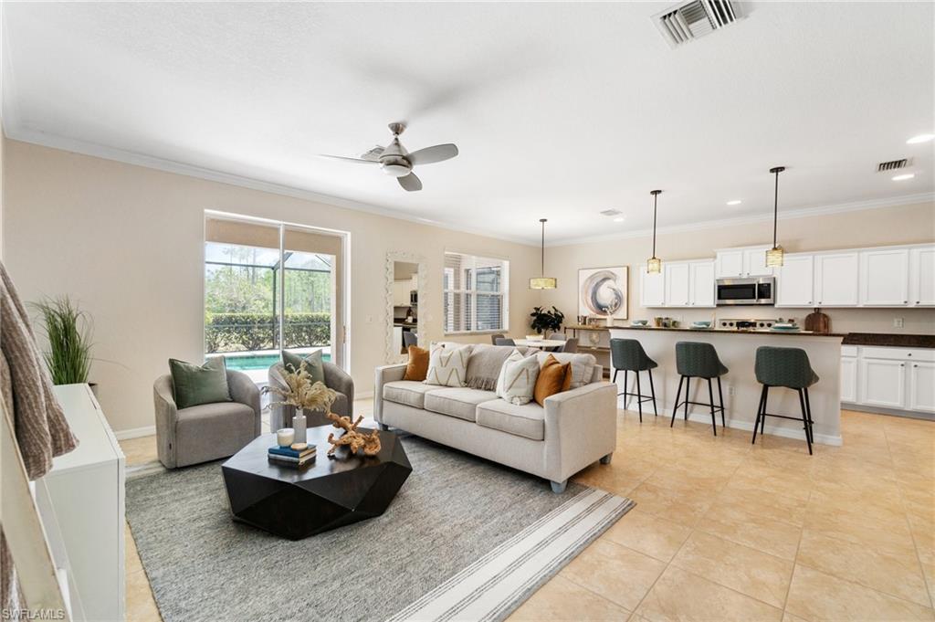 21017 Bella Terra Boulevard Estero, FL 33928 - Photo 4 of 45 a living room with furniture kitchen and a chandelier