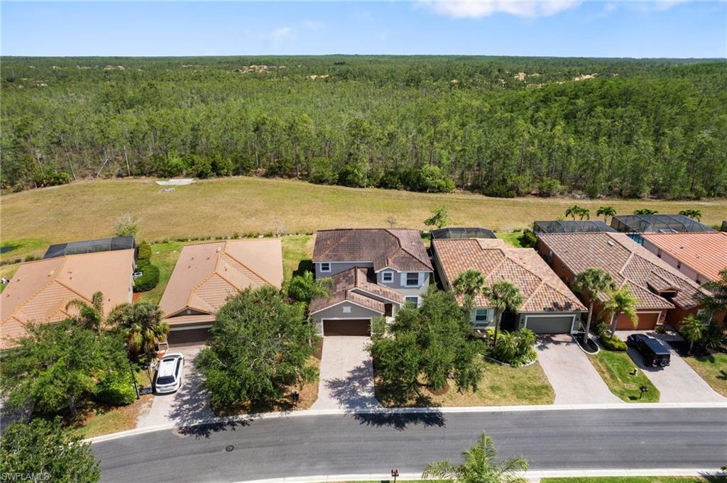 21017 Bella Terra Boulevard Estero, FL 33928 - Photo 44 of 45 an aerial view of residential houses with outdoor space and parking