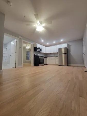 a view of empty room with a kitchen
