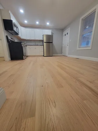 a view of a kitchen with a sink and a refrigerator