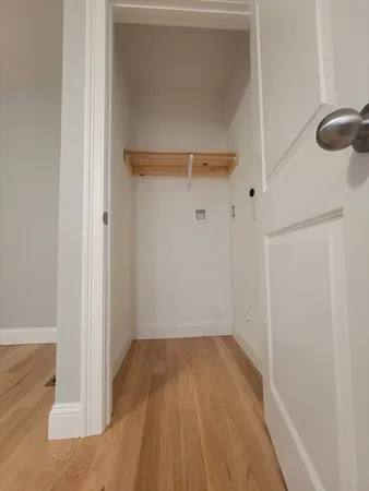 a view of a room with wooden floor