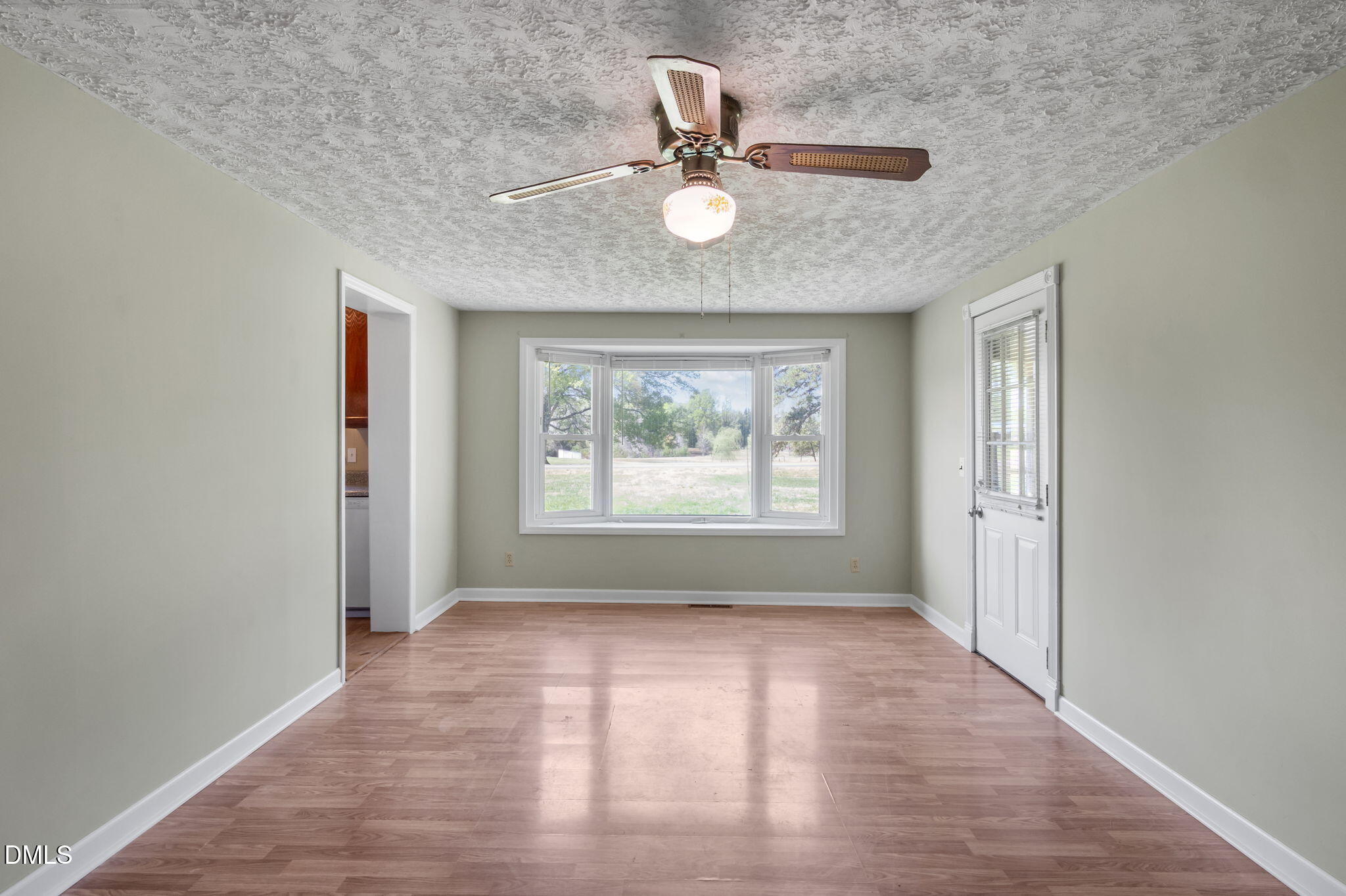 95 Harold Gill Road Roxboro, NC 27574 - Photo 11 of 53 wooden floor in an empty room with a window