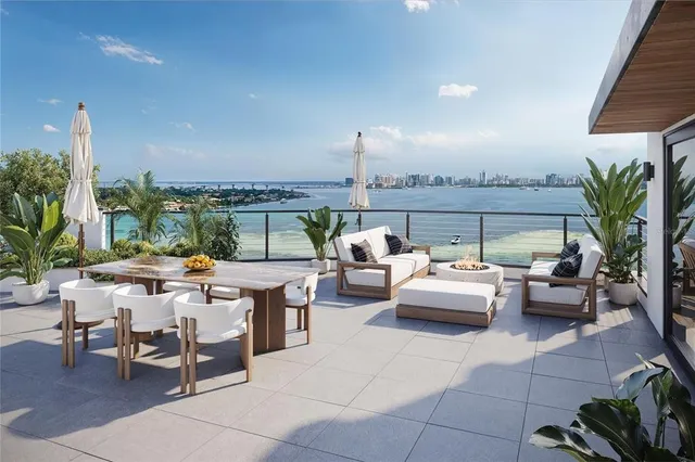 a living room with patio furniture and a potted plants