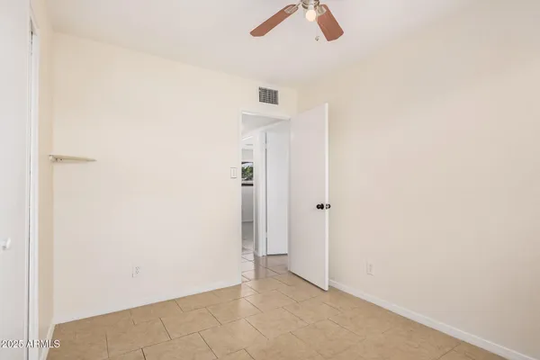 an empty room with ceiling fan