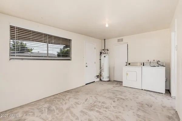 a view of a room with white cabinets