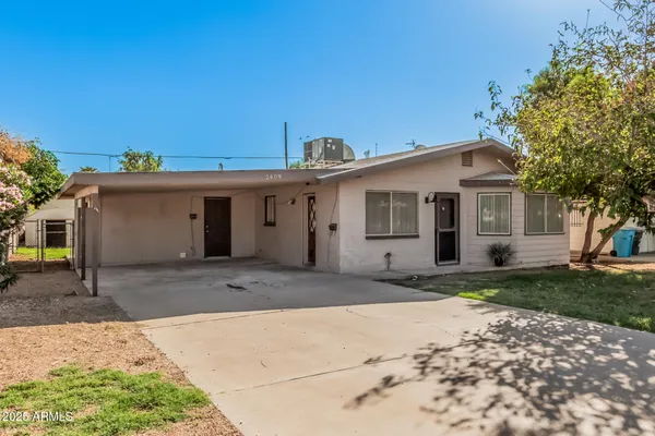 a front view of a house with a garden and yard