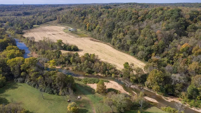 a view of a field with an trees