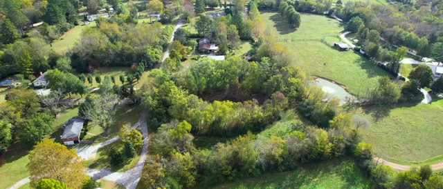 an aerial view of a residential apartment building with a yard