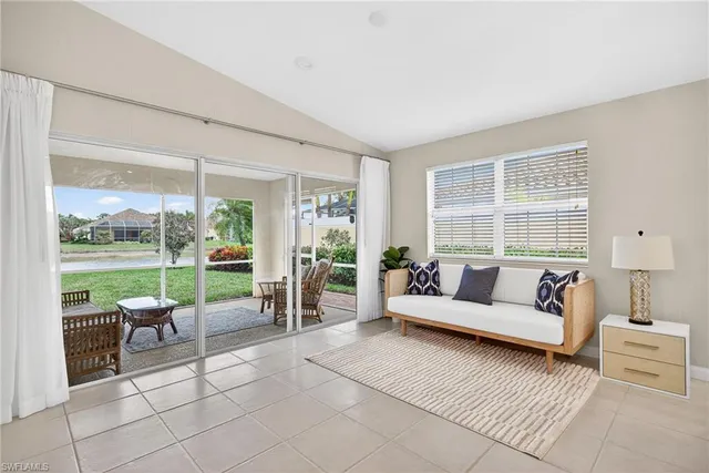 a living room with furniture and a floor to ceiling window