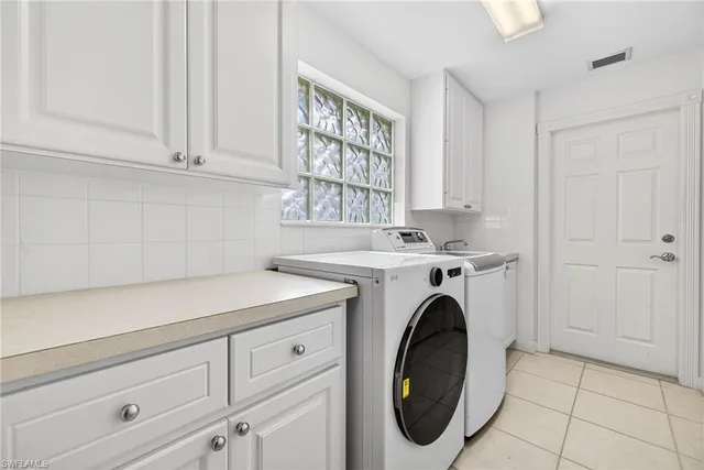 a utility room with sink dryer and washer