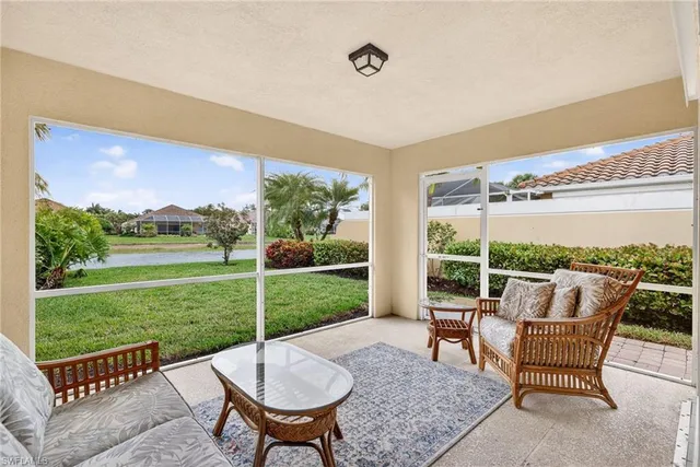 a view of a patio with a table chairs and a backyard