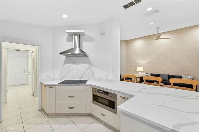 a kitchen with stainless steel appliances granite countertop a stove and a sink