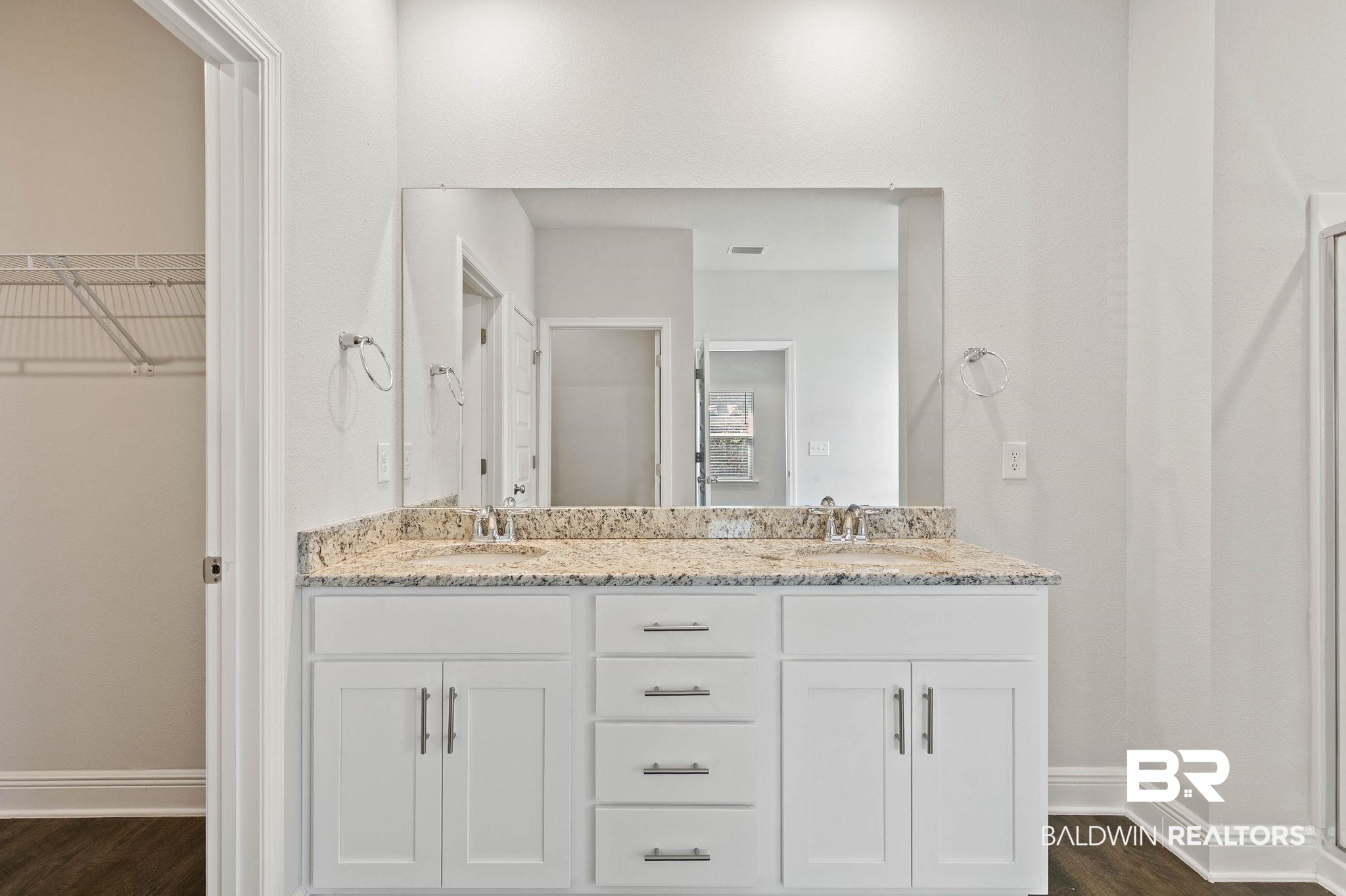 9448 Amethyst Drive Daphne, AL 36526 - Photo 27 of 61 Bathroom featuring double vanity, dark wood-style floors, a spacious closet, and a shower stall