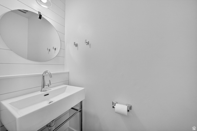 14771 Haddington Road Draper, UT 84020 - Photo 3 of 44 Modern rectangular sink with chrome faucet, complemented by a large oval mirror