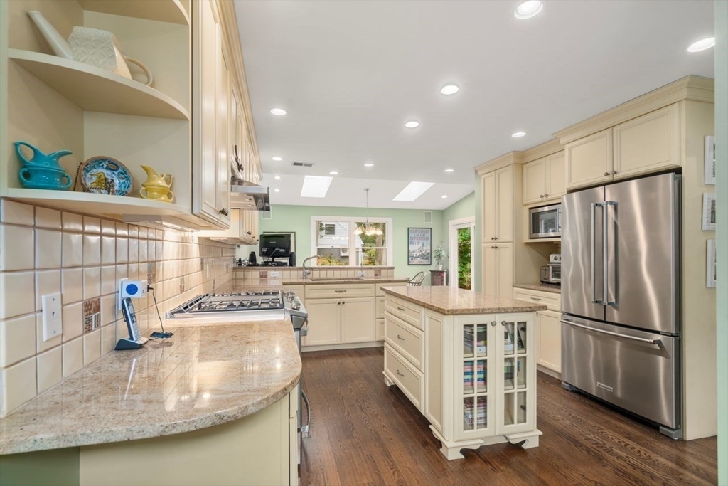34 Palmer Road Newton, MA 02468 - Photo 15 of 26 a kitchen with stainless steel appliances granite countertop a sink refrigerator and microwave
