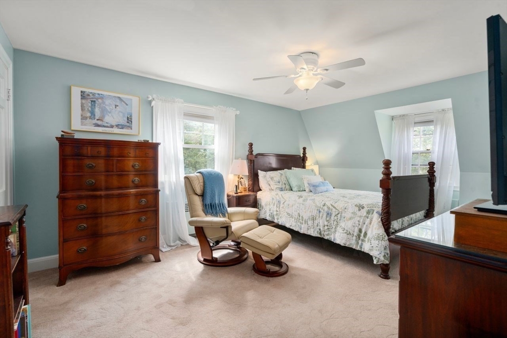 34 Palmer Road Newton, MA 02468 - Photo 18 of 26 a bedroom with a bed and a chandelier