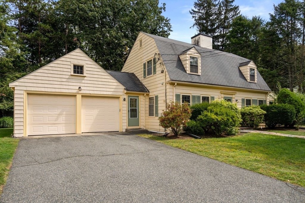 34 Palmer Road Newton, MA 02468 - Photo 2 of 26 a front view of a house with a yard and garage