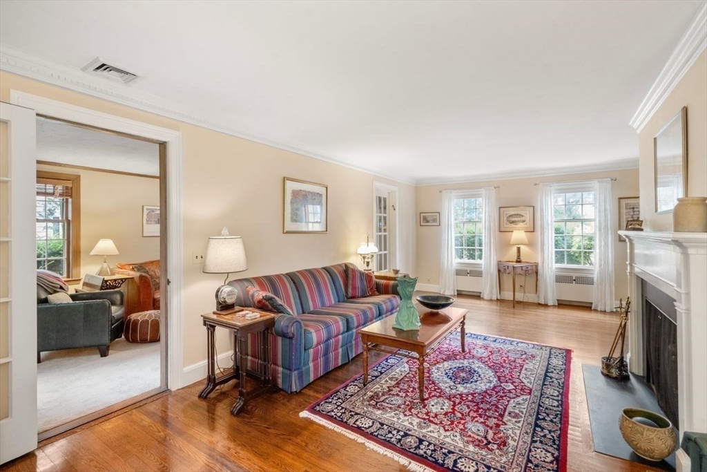 34 Palmer Road Newton, MA 02468 - Photo 6 of 26 a living room with furniture a rug a fireplace and a window
