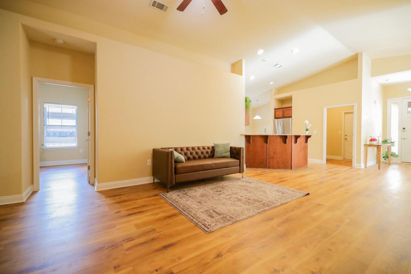 96 Benton Boulevard Freeport, FL 32439 - Photo 14 of 34 a living room with a couch and dresser with wooden floor