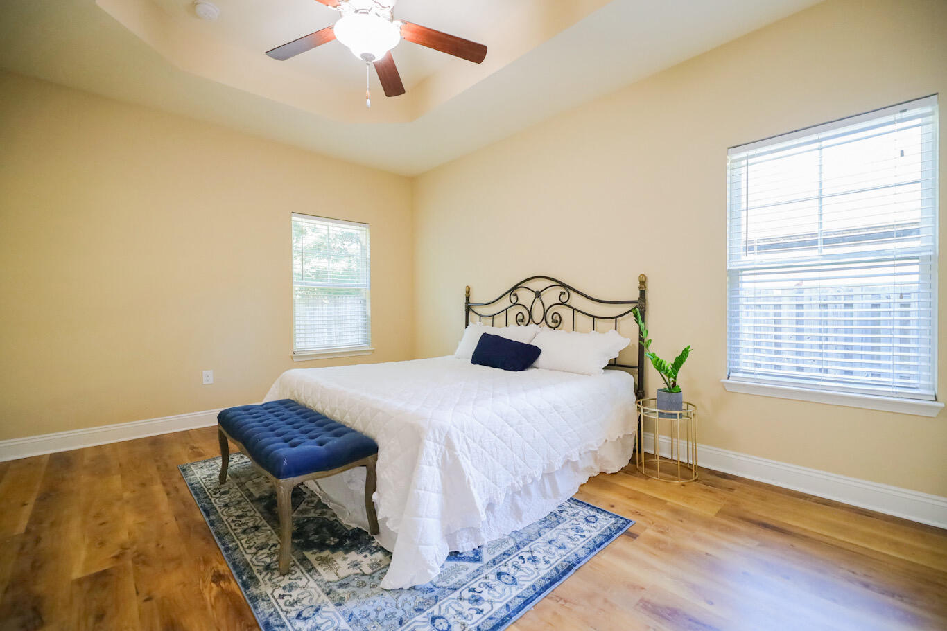 96 Benton Boulevard Freeport, FL 32439 - Photo 17 of 34 a bedroom with a bed and wooden floor