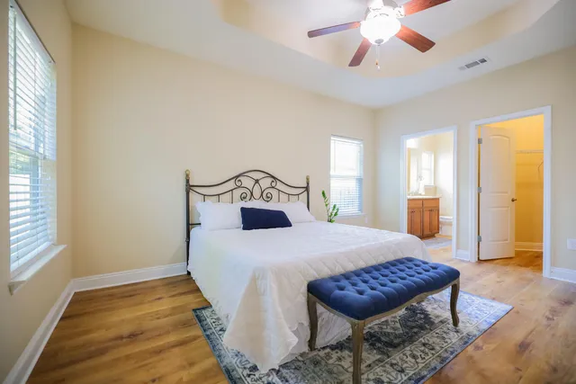 a bedroom with a bed and a large window