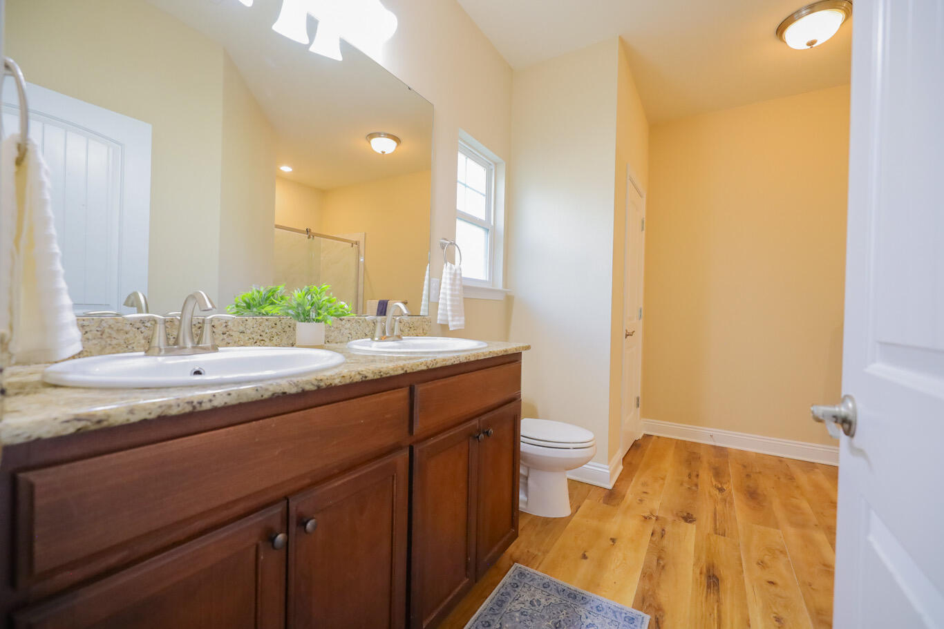 96 Benton Boulevard Freeport, FL 32439 - Photo 21 of 34 a bathroom with a granite countertop sink and a mirror