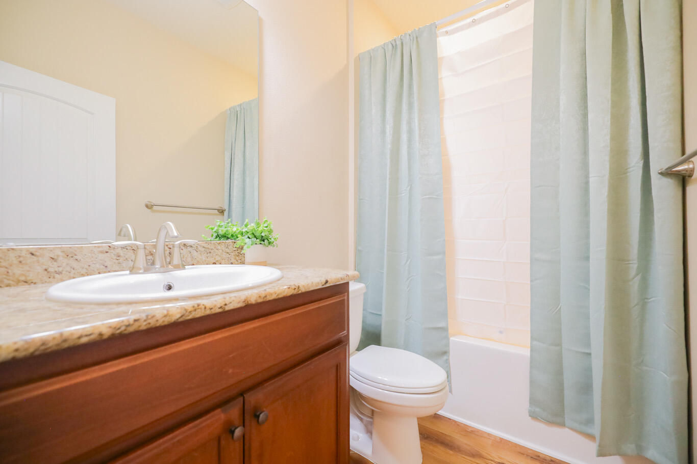 96 Benton Boulevard Freeport, FL 32439 - Photo 26 of 34 a bathroom with a granite countertop sink toilet and mirror