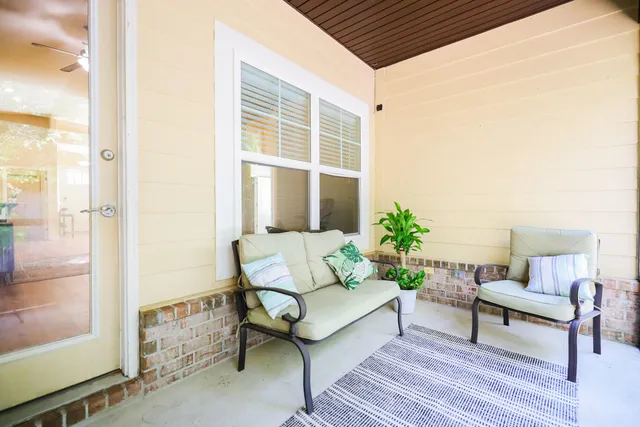 a chair and table in the back yard of a house