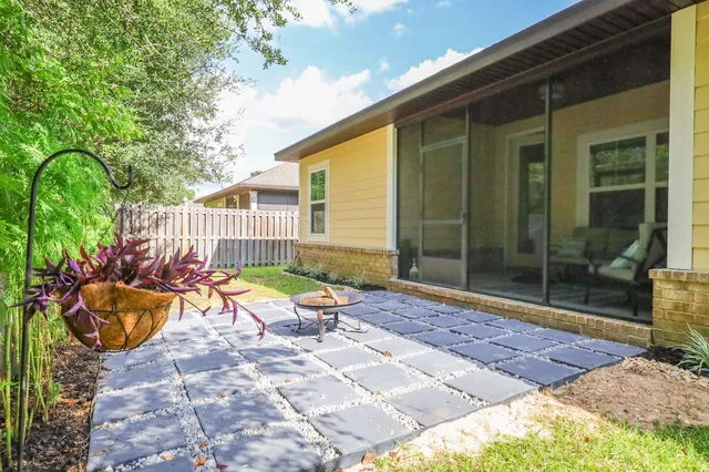 a view of backyard with a garden and deck