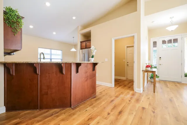 a kitchen with stainless steel appliances granite countertop a stove a sink and a microwave