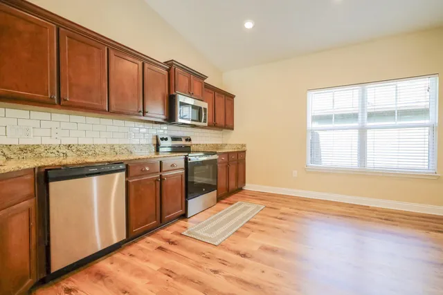 a view of a livingroom with wooden floor